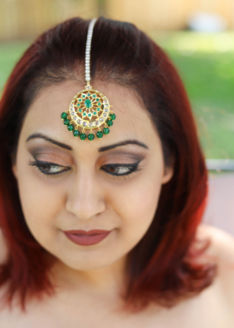 Polki tikka with emerald semi precious stones and green pearls